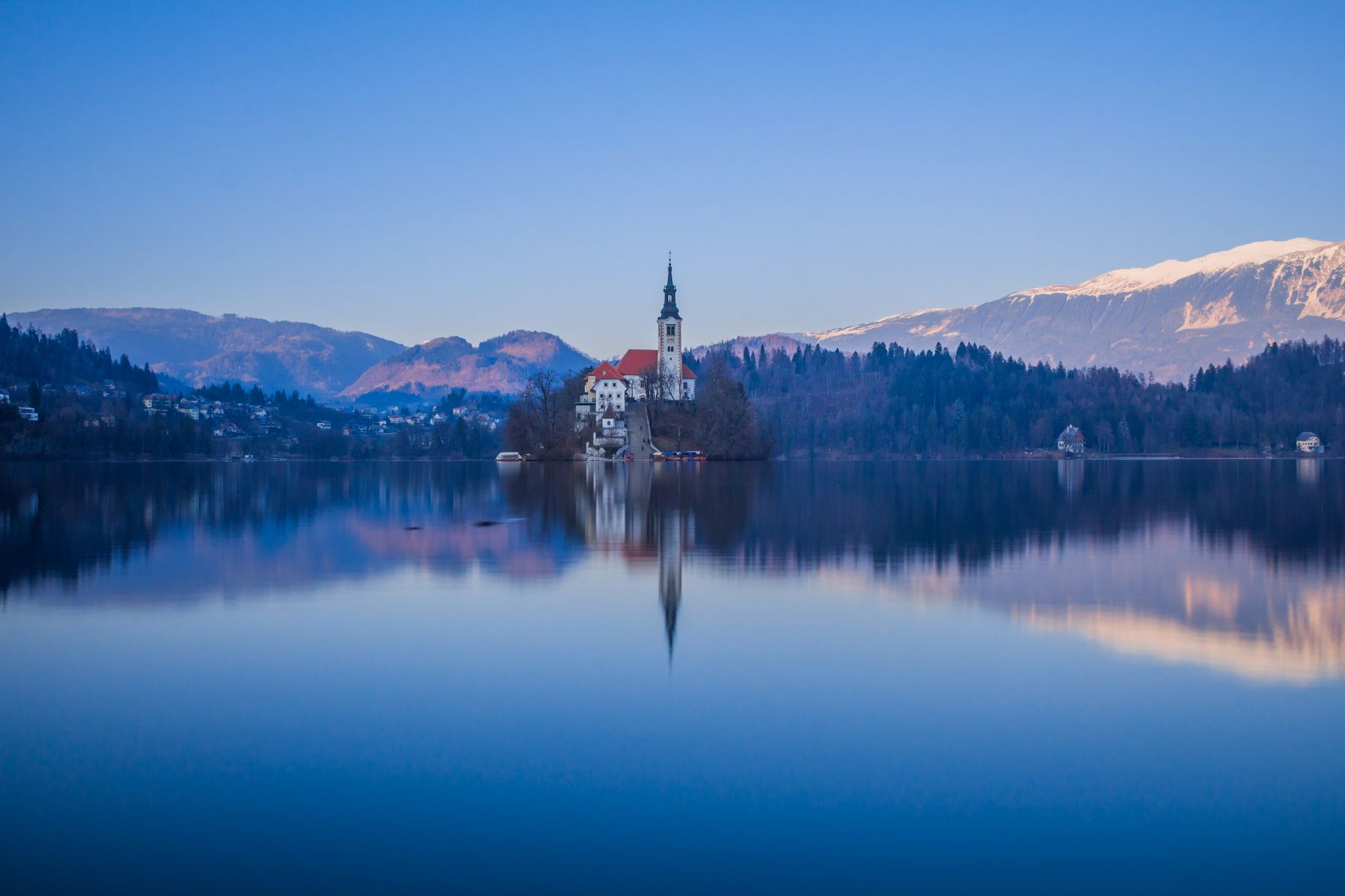 Lake Bled and its island church surrounded by mountains
